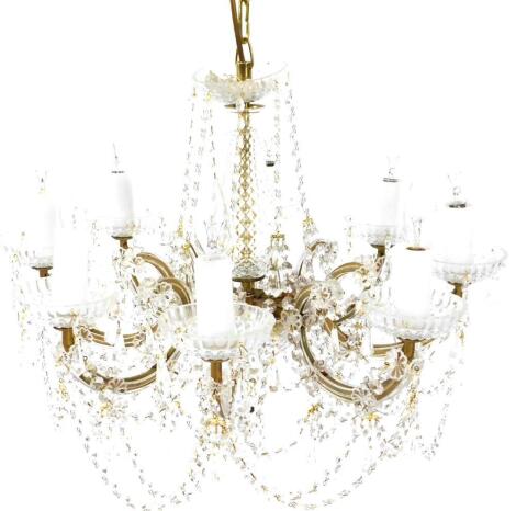 A cut glass and brass eight branch chandelier, with crystal festoons and tear drops, with seven fabric tasselled shades, 93cm high, 56cm diameter.