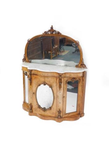 A Victorian walnut serpentine fronted mirror back sideboard, the domed mirror with carved fruit surmounts, white marble top, over three mirror set doors, opening to reveal shelves, raised on a plinth base, 152cm high, 122cm wide, 44cm deep.