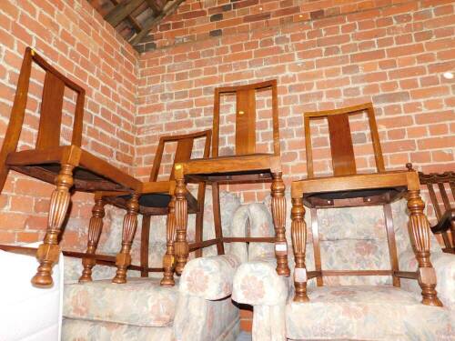 A set of four early 20thC oak dining chairs, with rexine seats and turned and reeded legs.