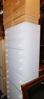 A pair of white melamine six drawer chests, 100cm high, 77cm wide, 39cm deep., together with a pair of rattan three drawer bedside chests, 66cm high, 42cm wide, 35cm deep. (4)