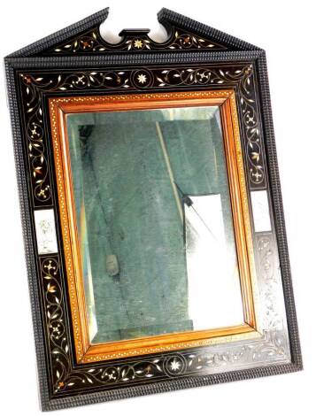 A late 19thC continental ebony, bone and marquetry wall mirror, with a broken pediment, a ripple moulded border, a mahogany slip and foliate and scrolling bands, inset with incised decoration and two ivory panels depicting figures wearing head dresses, et