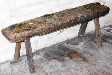 A rustic trestle bench, 43cm high, 125cm long.