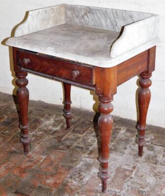 A Victorian mahogany wash stand, with marble top, frieze drawer with knob handles and turned legs, 76cm high, 72cm wide, 54cm deep.