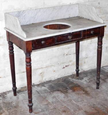 An early Victorian mahogany washstand, with marble tray top having recess, two frieze drawers and turned legs, 92cm wide.
