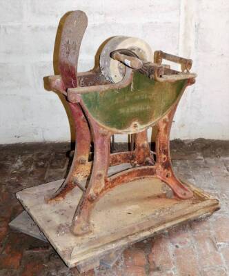 A 19thC cast iron treadle based and hand wind optioned cast iron grinding wheel, on wooden base, the base being 60cm x 80cm.