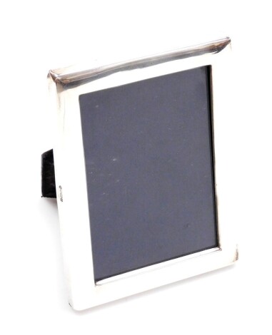 An Elizabeth II silver photograph frame, of rectangular design, with a blue velvet back, Sheffield 1988, 16cm x 12cm.