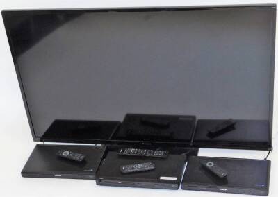 A Panasonic 49" flat screen television, with various accessories, the television with power lead, remote control and operating manual, model TX-50A300B, together with a Logik DVD player with remote and two Philips DVD players, each with remote. (4)