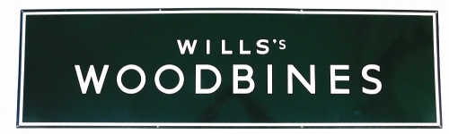 A large enamel advertising sign marked Wills's Woodbines, on green and white enamelling, 153cm wide, 43cm high.