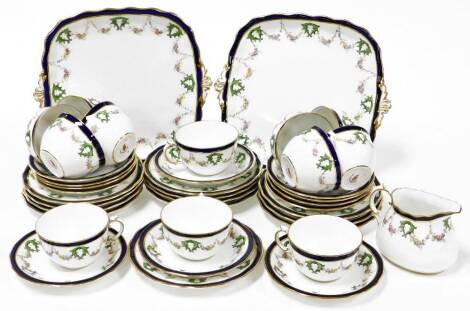 A Royal Crown Derby part tea and dinner service, comprising of two cake plates, milk jug, twelve tea cups and saucers and twelve side plates, each with dark red Royal Crown Derby stamp to underside.
