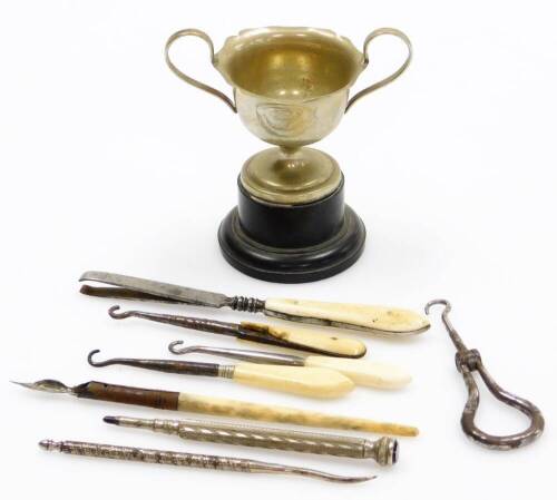 A silver plated GMS trophy cup, dated August 2nd 1937, and various silver plated and bone handled button hooks, together with a silver plated pencil stand. (a quantity)