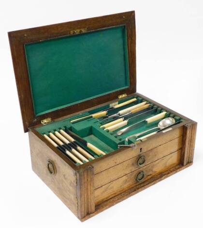 A cased canteen of silver plated Walker and Hall cutlery, the oak case opening to reveal Walker and Hall bone handled knives, teaspoons, mustard spoons, forks, and two drawers with spoons, incomplete, 19cm high, 48cm wide, 4cm deep.