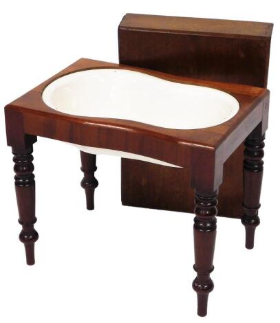 A Victorian mahogany bidet, the rectangular removable cover enclosing a shaped ceramic basin on turned tapering legs, the largest table 47cm high, 53cm wide, 43cm deep, the cabinet is 75cm high, 87cm wide, 26cm deep.