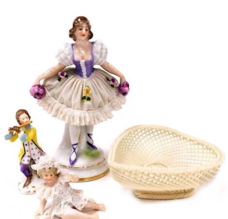 A group of ceramics, to include a Cath Dainty crinoline figure of a lady in ballerina type dressing together with a Belleek heart shaped basket, a Sampson style miniature figure of a gentleman playing a flute and a porcelain crinoline type figure of a sea