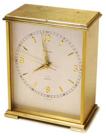 A Garrard mantel timepiece, with silvered coloured dial, Swiss Quartz movement, in gold coloured casing, with carrying handle, 14cm high.