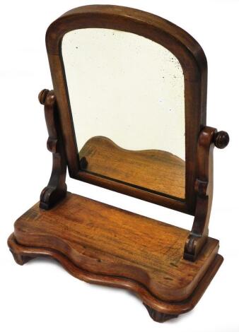 A late 19thC mahogany framed swing mirror, with rectangular mirror top, on a curved base, 54cm high, 38cm wide, 18cm deep.