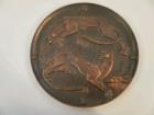 A Russian cast copper alloy circular plaque depicting two Art Deco stylised big cats