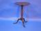 An early 19thC circular top mahogany pedestal tripod table