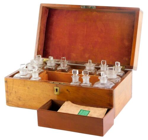 A 19thC mahogany medicine box, the rectangular hinged lid enclosing a series of bottles and stoppers, brass scales with weights, and a copy of Cox's Companion to the Family Medicine Chest, bottles incomplete, 33cm wide.