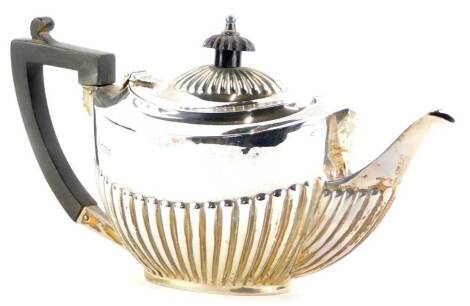 A Victorian silver teapot, with part reeded decoration, and ebonised knop and angular handle, Sheffield 1900, 7½ oz all in.