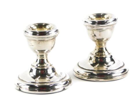 A pair of Elizabeth II dwarf candlesticks, loaded bases, Sheffield 1972, 6cm high. (2)