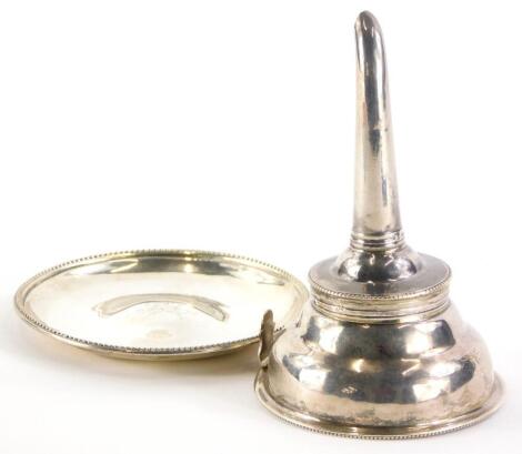 A late 18thC/early 19thC silver wine funnel, with beaded border, indistinct marks, and a stand, monogrammed RA, with beaded border, 7cm diameter, (associated, 2)