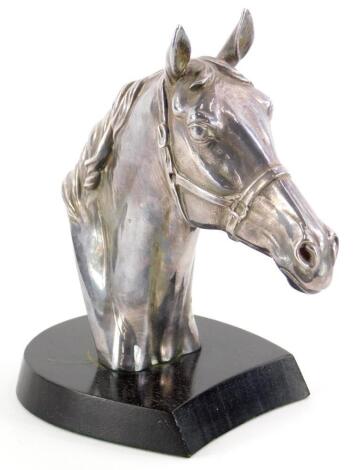 An Elizabeth II silver cast head of a horse, on a hardwood base, signed Donald Brindley, Sheffield 1989, 16cm high.