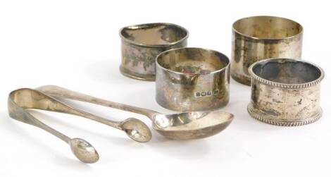 A collection of small silver, to include sugar tongs, napkin rings, 4cm diameter, spoon, etc., 4½oz.