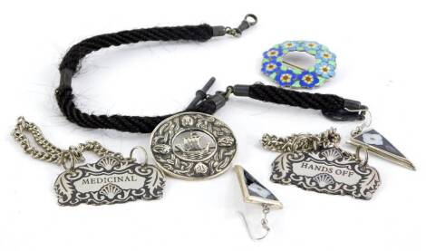 A small group of costume jewellery and effects, to include a watch chain, a silver and enamel floral brooch, a pair of Mexican drop earrings, a silver ship brooch and two decanter labels. (6)