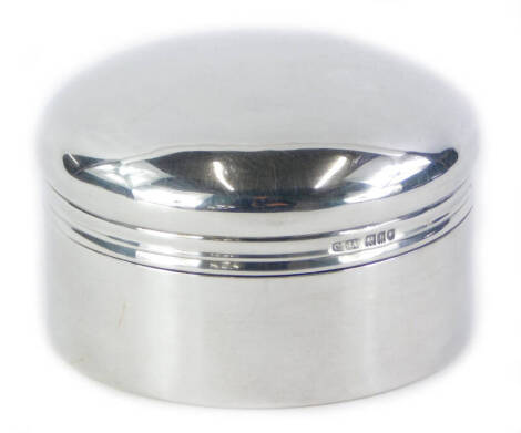 An Edwardian circular silver dressing box and cover, London 1906, retailed by Aspreys, 3¾oz, 8cm diameter.