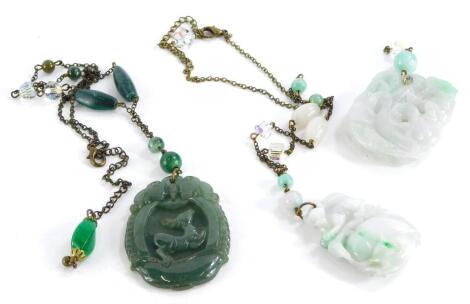 A small group of jade necklaces, to include pale green jade carved necklaces, one of monkeys on a branch, the other of a dog on boot, together with a dark green open pendant of a deer. (3)