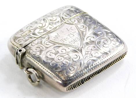 A silver Vesta case, with floral engraved decoration and shield front, with initials W K December 25th 1903, Birmingham 1901.