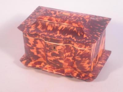 An early 19thC tortoiseshell tea caddy of serpentine form