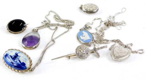 Various silver pendants and chains, comprising a silver oval pendant and chain, silver heart shaped pendant and chain, a silver dagger brooch, a miniature silver pendant, a silver Wedgwood pendant and chain, a silver framed Delft style brooch and silver a