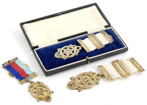 A collection of silver Masonic jewels, each with scroll decorated buckles, etc., two hallmarked, the other stamped silver. (3)