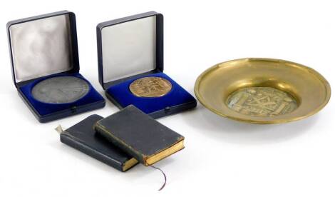 A collection of Masonic items, to include a brass ashtray or dish, a base metal medal stamped IPA Verbindungstelle Karlsruhe, and another Corp de Police Lausanne, and two Masonic craft books, one stamped Mackenzie and Co, etc.