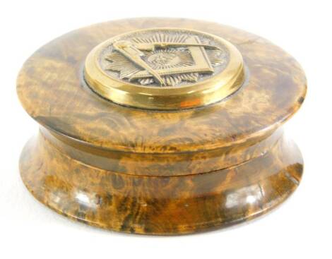 A late 19th/early 20thC turned burr wood Masonic snuff box, the lid applied with emblems and with initials F and U, enclosing a tortoiseshell interior, (AF), 5.5cm diameter.