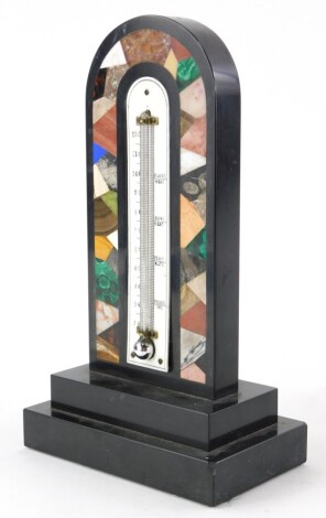 A 19thC black slate and specimen stone table thermometer, the arched top with a central mercury thermometer, surrounded by inlaid bands of malachite, onyx, various coloured marbles, etc., on a stepped rectangular base, 22cm high. Provenance: Butterfields