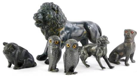 A collection of cast pewter animals, to include a lion, seated pug, a pig, two owl cruets, etc.