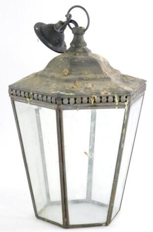 A dark patinated brass lantern, with tapering bevelled glass to the hexagonal pierced top, 28cm high.