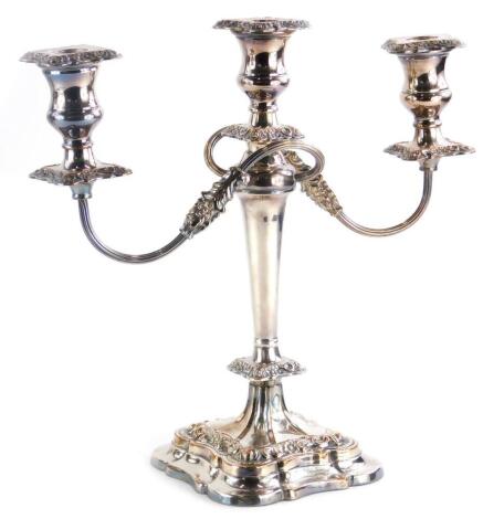 A silver plated three branch candelabrum, engraved 'presented to Inspector BJ Rowe on his retirement from the Nottingham City Police, 1925 to March 1955,' 35cm high, 36cm wide.