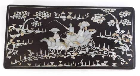 An oriental lacquered panel, inlaid with mother of pearl, depicting figures in a stagecoach, pulled by horses, possibly Chinese, 29.5cm x 59.5cm.