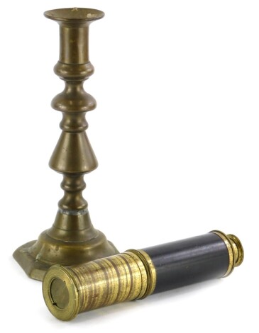 A small four draw brass and mahogany telescope, unmarked, 17cm long, (AF), and a brass candlestick.