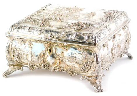 A Walker and Hall silver plated jewellery box, cast with Watteauesque scenes of a terrace within rococo scroll borders, the base with similar decoration surrounding a central cartouche, with key on scroll feet, 10cm high, 20cm wide.