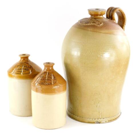 A stoneware four gallon flagon, stamped M Tuckwood, Grantham, (AF), 47cm high, a smaller stoneware bottle for Jane Nicolls of Sleaford, and another for C Pratt and Son of Lincoln.