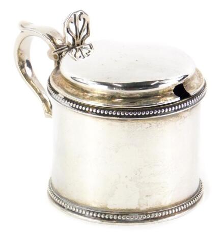 A Victorian Scottish silver mustard pot, with bead border decoration, lacking blue glass liner, Edinburgh 1874, 3¾oz.