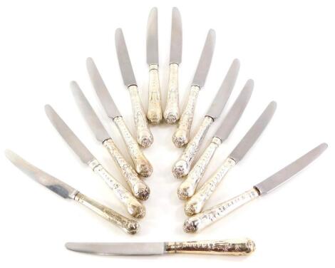 A set of thirteen Victorian silver handled knives, with stainless steel blades, the handles cast with scrolls, shells, etc. (13)