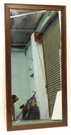 An oak rectangular wall mirror, with a beaded border, 162cm x 83cm.