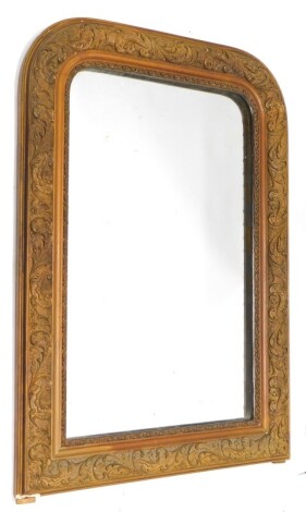 A gilt overmantel mirror, cast with scrolls, leaves, etc. and with an arched top, 90cm high, 62cm wide.