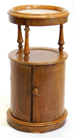 A Victorian mahogany cylindrical pot cupboard, the top with a moulded gallery above a white marble insert, on turned supports, the base with a single door with a turned wooden handle on a plinth, 74cm high, 40cm diameter. (AF)