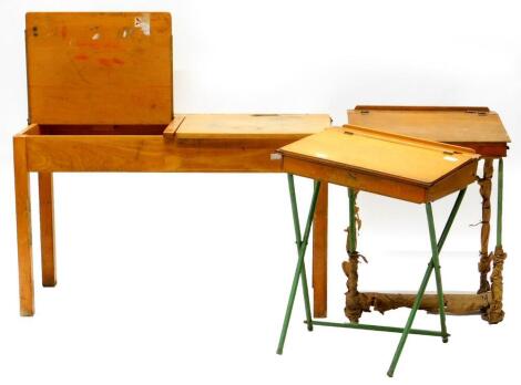 A Tri-ang child's vintage desk, with hinged top and metal legs, another similar desk and a double child's desk. (3)